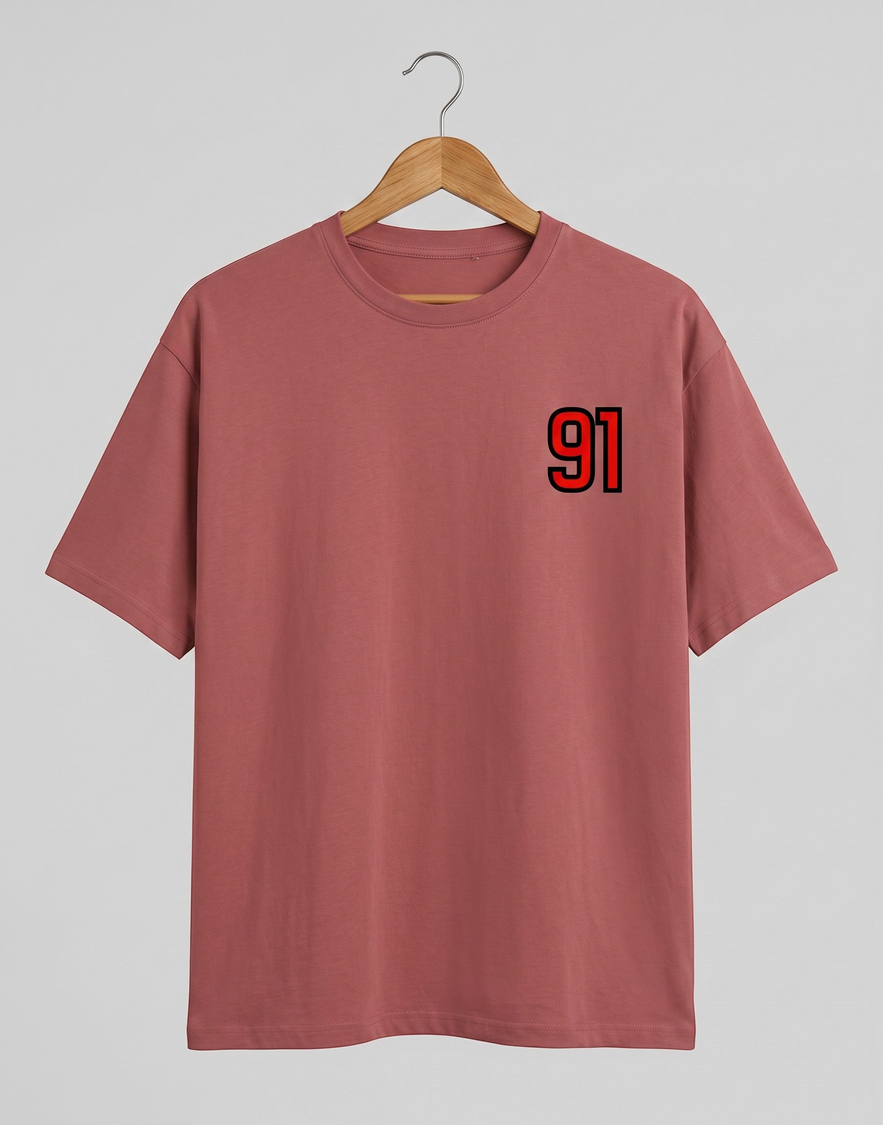 91 Varsity Left Chest graphic t-shirt on CORAL unisex classic crew soft-touch 180 GSM cotton, bold red varsity 91 left-chest pocket print signature, black outline varsity number, minimalist placement subtle distinctive, classic crew neckline timeless, unisex regular fit flattering, pre-shrunk bio-washed maintains shape