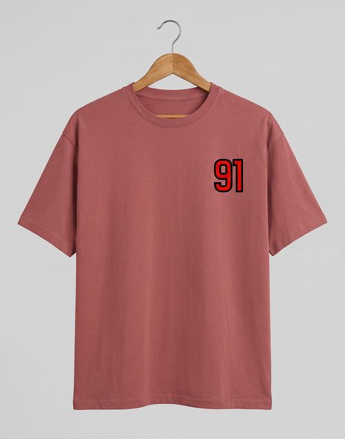 91 Varsity Left Chest graphic t-shirt on CORAL unisex classic crew soft-touch 180 GSM cotton, bold red varsity 91 left-chest pocket print signature, black outline varsity number, minimalist placement subtle distinctive, classic crew neckline timeless, unisex regular fit flattering, pre-shrunk bio-washed maintains shape