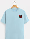 91 Varsity Left Chest graphic t-shirt on BABY BLUE unisex classic crew soft-touch 180 GSM cotton, bold red varsity 91 left-chest pocket print signature, black outline varsity number, minimalist placement subtle distinctive, classic crew neckline timeless, unisex regular fit flattering, pre-shrunk bio-washed maintains shape