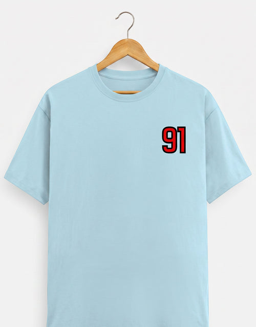 91 Varsity Left Chest graphic t-shirt on BABY BLUE unisex classic crew soft-touch 180 GSM cotton, bold red varsity 91 left-chest pocket print signature, black outline varsity number, minimalist placement subtle distinctive, classic crew neckline timeless, unisex regular fit flattering, pre-shrunk bio-washed maintains shape