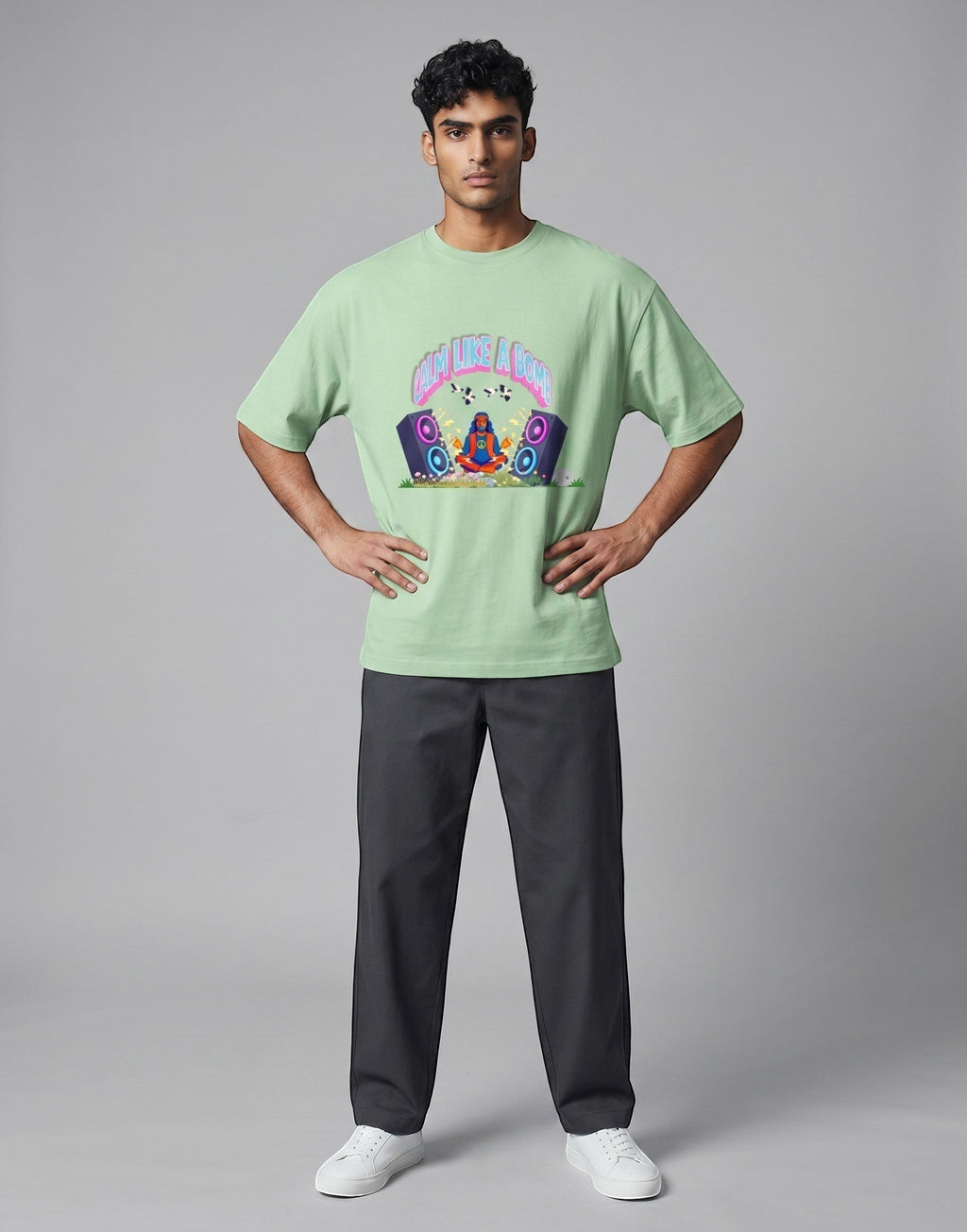 Calm Like A Bomb graphic t-shirt on jade unisex 100% cotton crew neck, featuring meditative figure with retro speakers, DTG print 300 DPI