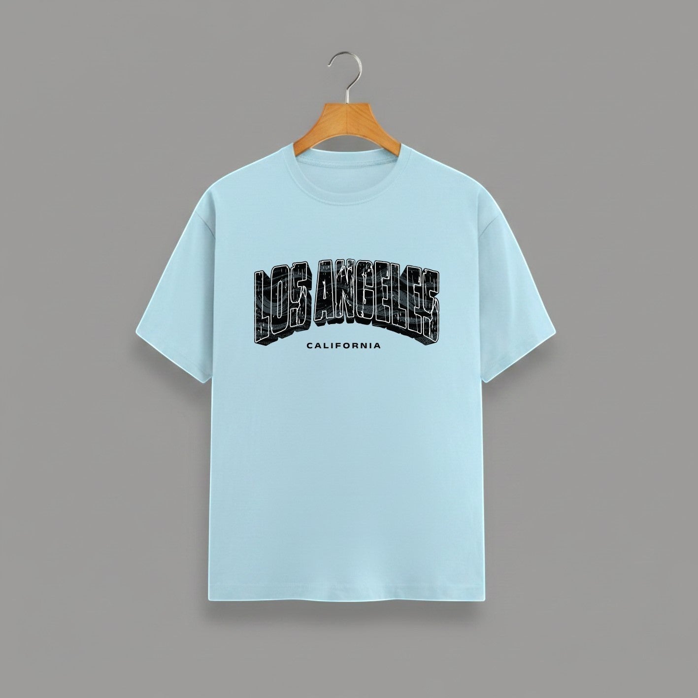 Los Angeles California graphic t-shirt on BABY BLUE unisex classic crew soft-touch 180 GSM cotton, distressed LOS ANGELES collegiate arch lettering bold CA graphic, California subtitle clean spaced caps, monochrome black-on-white minimal versatile, classic crew neckline timeless, unisex regular fit flattering, pre-shrunk bio-washed maintains shape