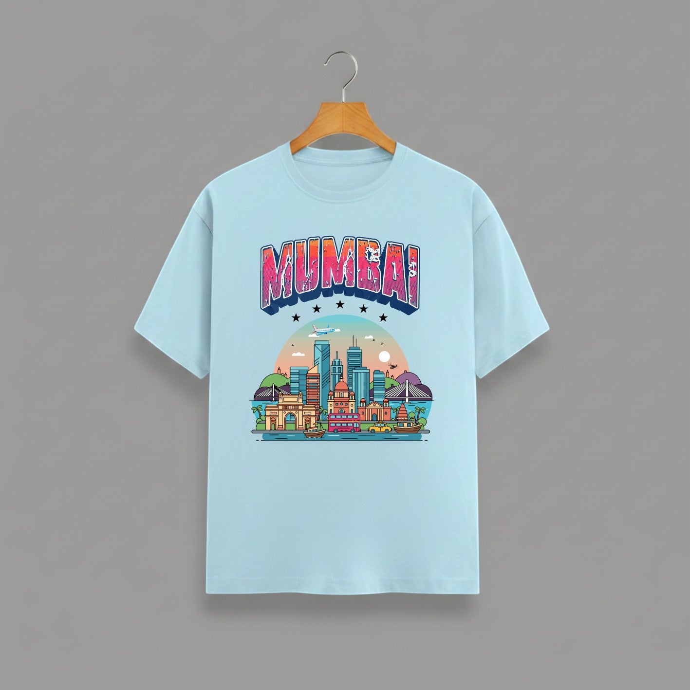 Mumbai Meri Jaan graphic t-shirt with bold MUMBAI lettering, BABY BLUE vibrant skyline artwork, Gateway of India and Bandra-Worli Sea Link city landmarks, unisex classic crew fit, soft 180 GSM cotton tee