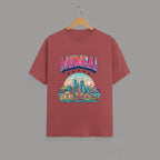 Mumbai Meri Jaan graphic t-shirt with bold MUMBAI lettering, CORAL vibrant skyline artwork, Gateway of India and Bandra-Worli Sea Link city landmarks, unisex classic crew fit, soft 180 GSM cotton tee