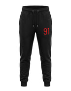 Tribe Neo 91 black unisex cotton fleece joggers featuring a bold red 91 graphic on the left thigh and ribbed cuffs.