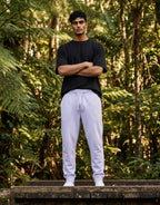 Tribe Neo 91 unisex lavender joggers with ribbed cuffs and drawstring waist worn by a man in a forest setting