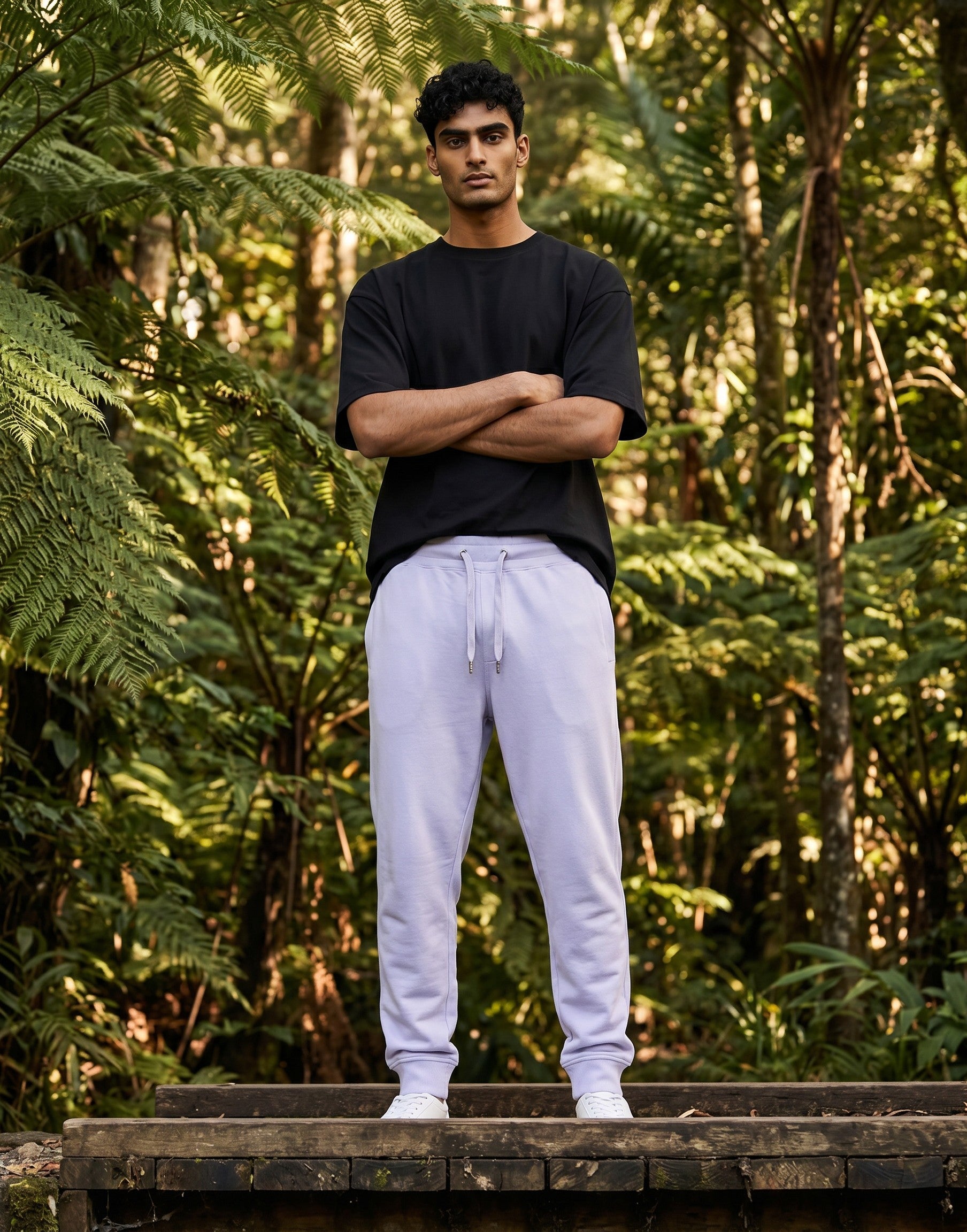 Tribe Neo 91 unisex lavender joggers with ribbed cuffs and drawstring waist worn by a man in a forest setting