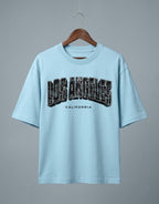 Tribe Neo 91 light blue oversized cotton t-shirt with distressed Los Angeles California cityscape graphic print.