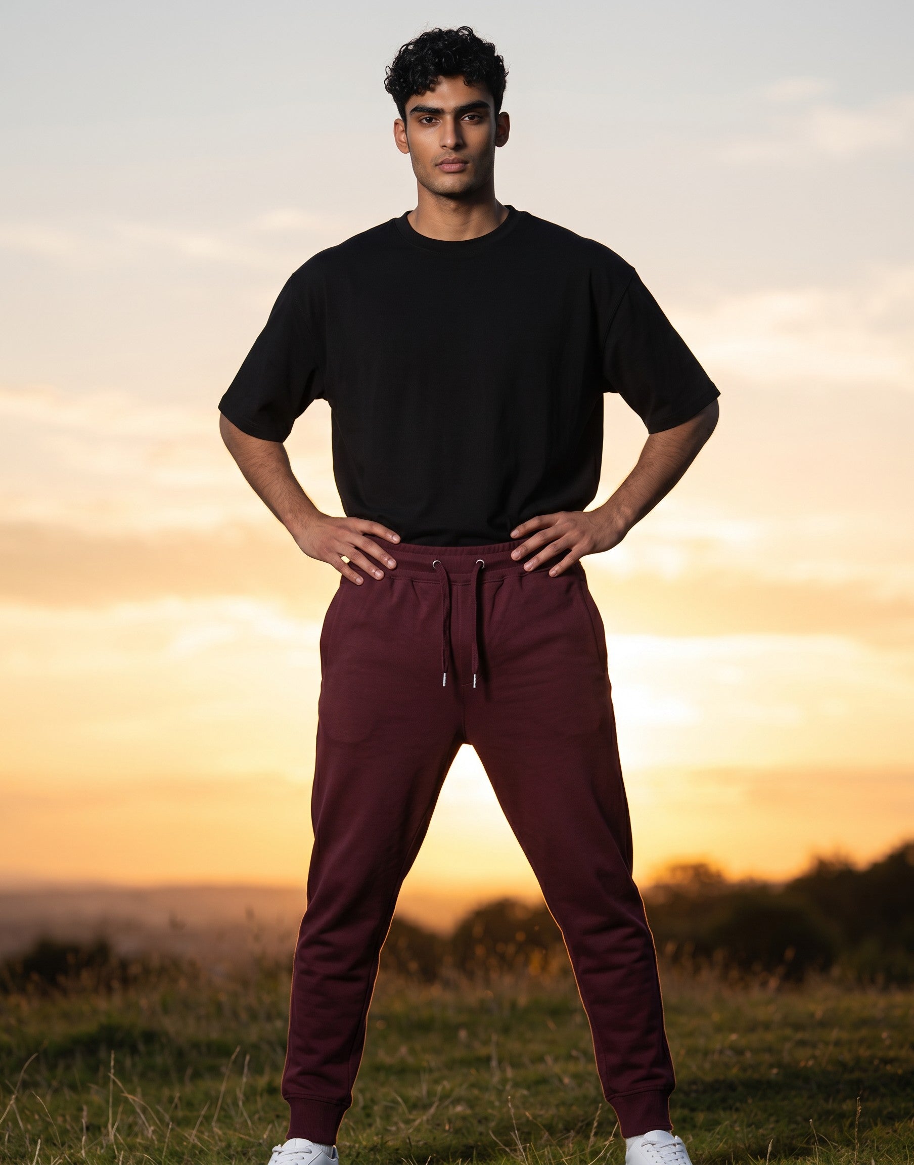 Tribe Neo 91 maroon unisex cotton fleece joggers with ribbed cuffs and drawstring waist worn by a man outdoors