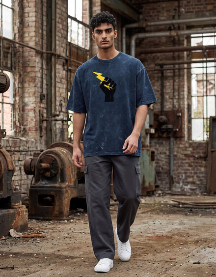 Tribe Neo 91 navy blue acid wash oversized cotton tee with a black fist and yellow lightning bolt graphic on a model