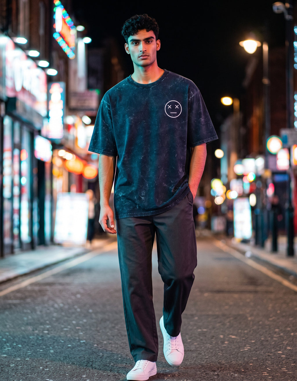 Tribe Neo 91 navy blue acid wash oversized cotton t-shirt with a small XX dead emoji graphic on a city street at night.