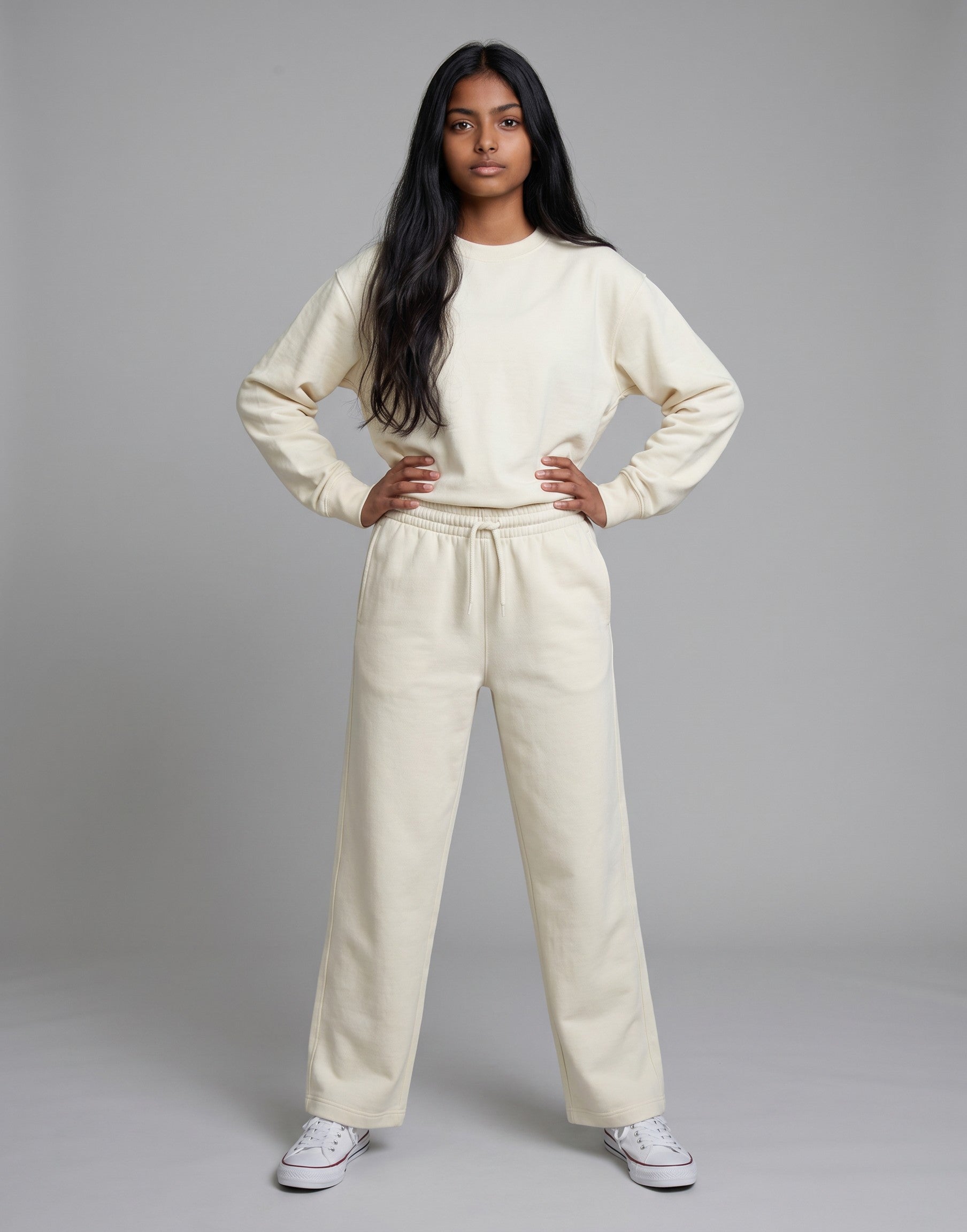 A model wearing Tribe Neo 91 off-white wide-leg cotton sweatpants and matching sweatshirt with an elastic drawstring.