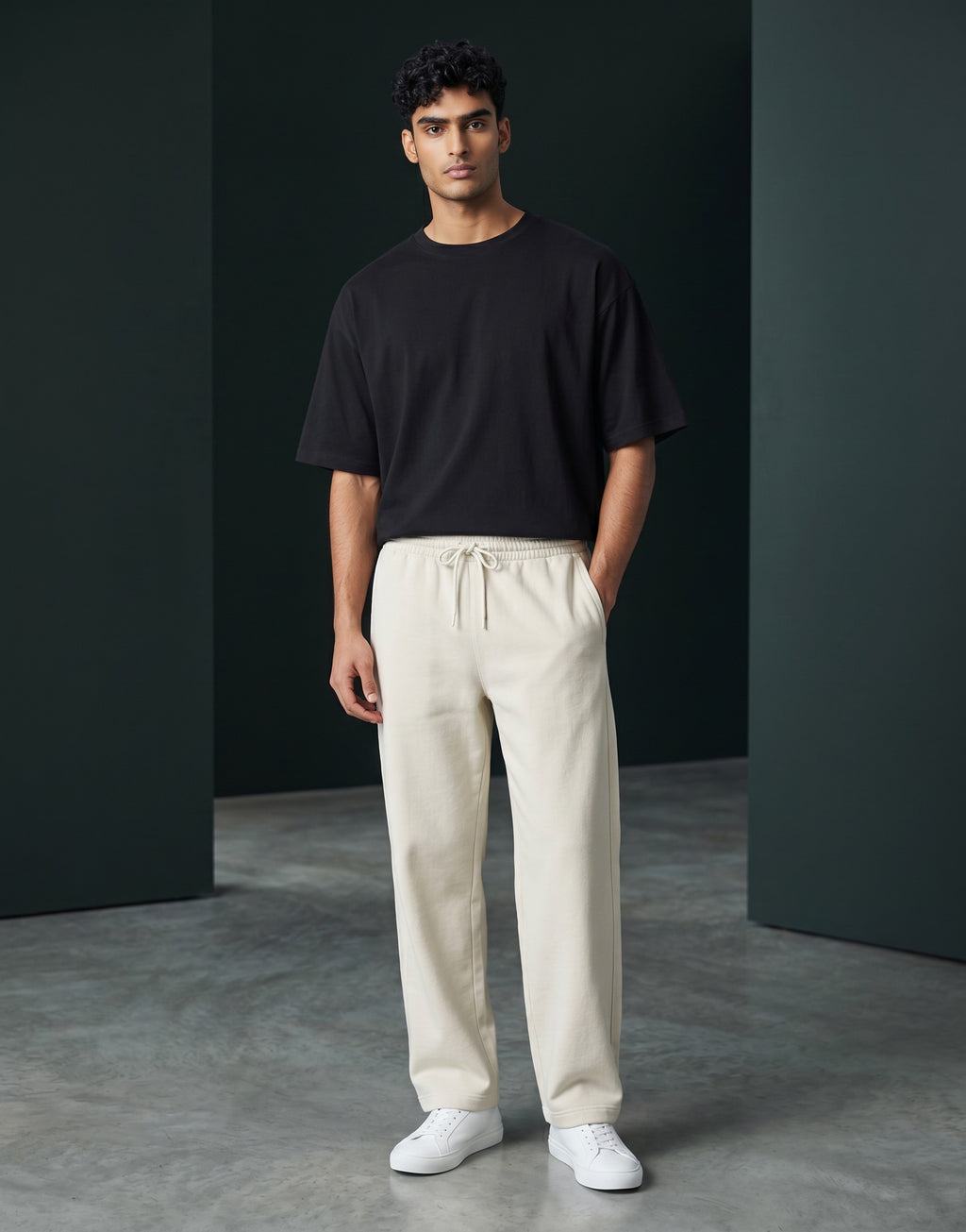 Male model wearing Tribe Neo 91 off-white wide-leg cotton sweatpants with a drawstring waist and black t-shirt