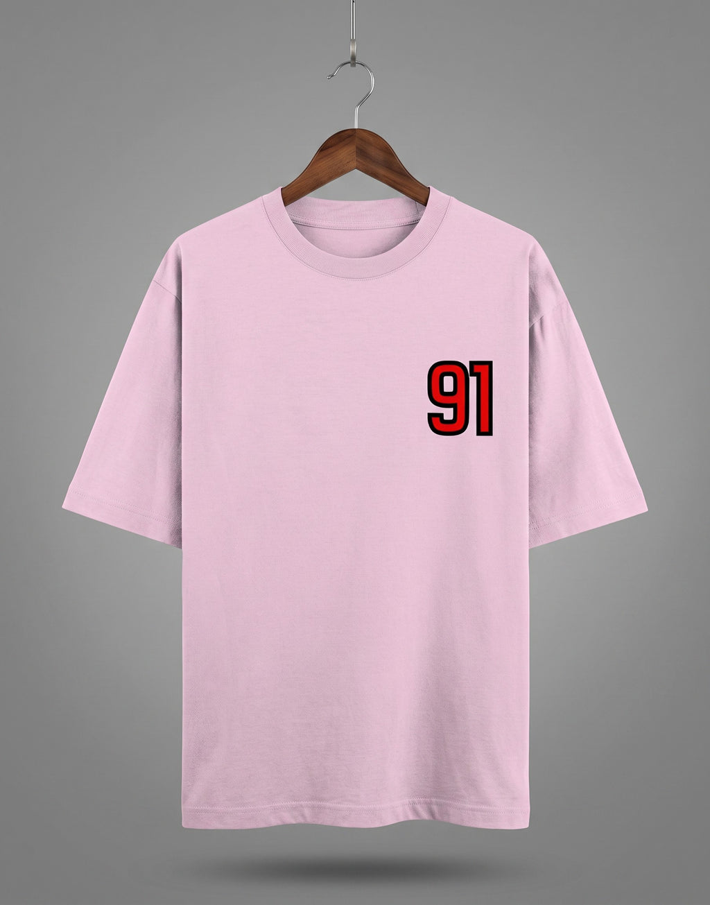 Tribe Neo 91 light pink heavyweight cotton oversized t-shirt with a red and black 91 left chest print on a hanger.