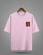 Tribe Neo 91 light pink heavyweight cotton oversized t-shirt with a red and black 91 left chest print on a hanger.