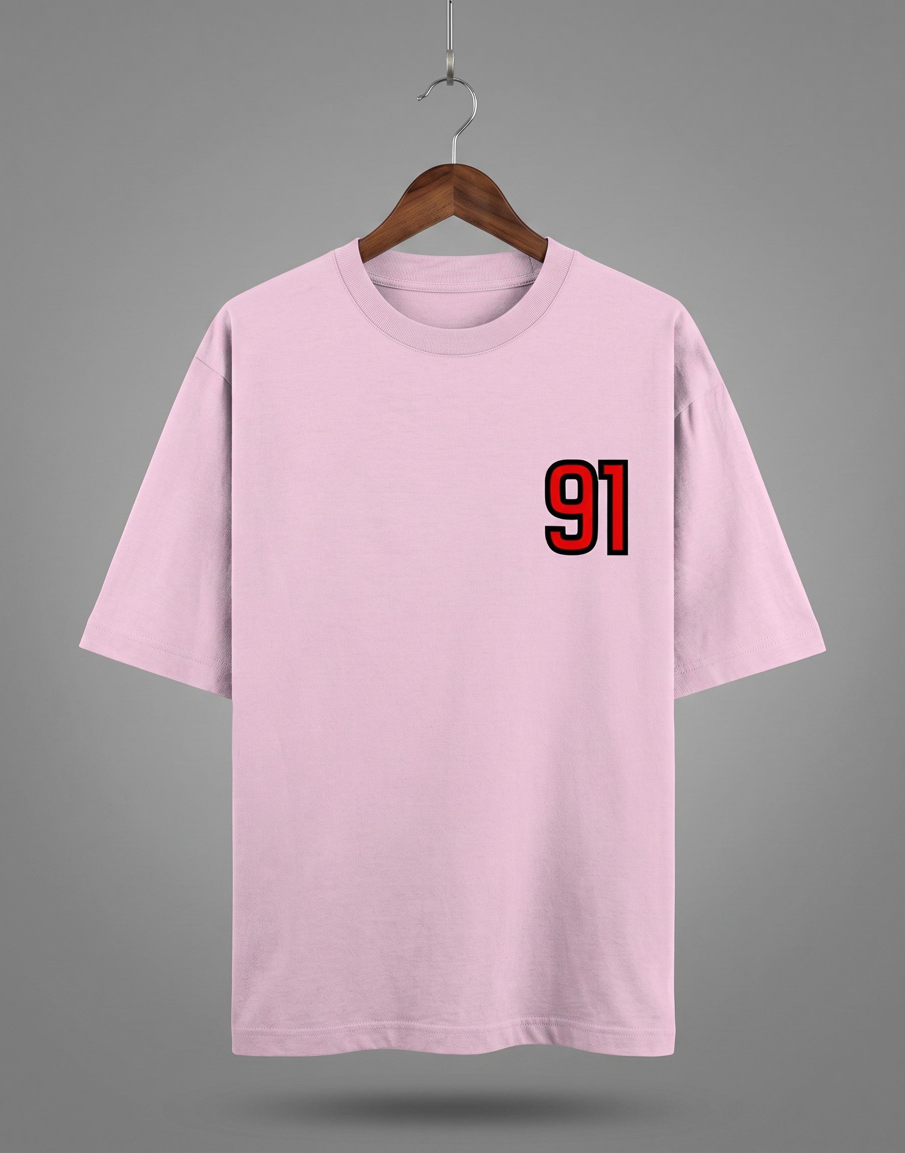 Tribe Neo 91 light pink heavyweight cotton oversized t-shirt with a red and black 91 left chest print on a hanger.