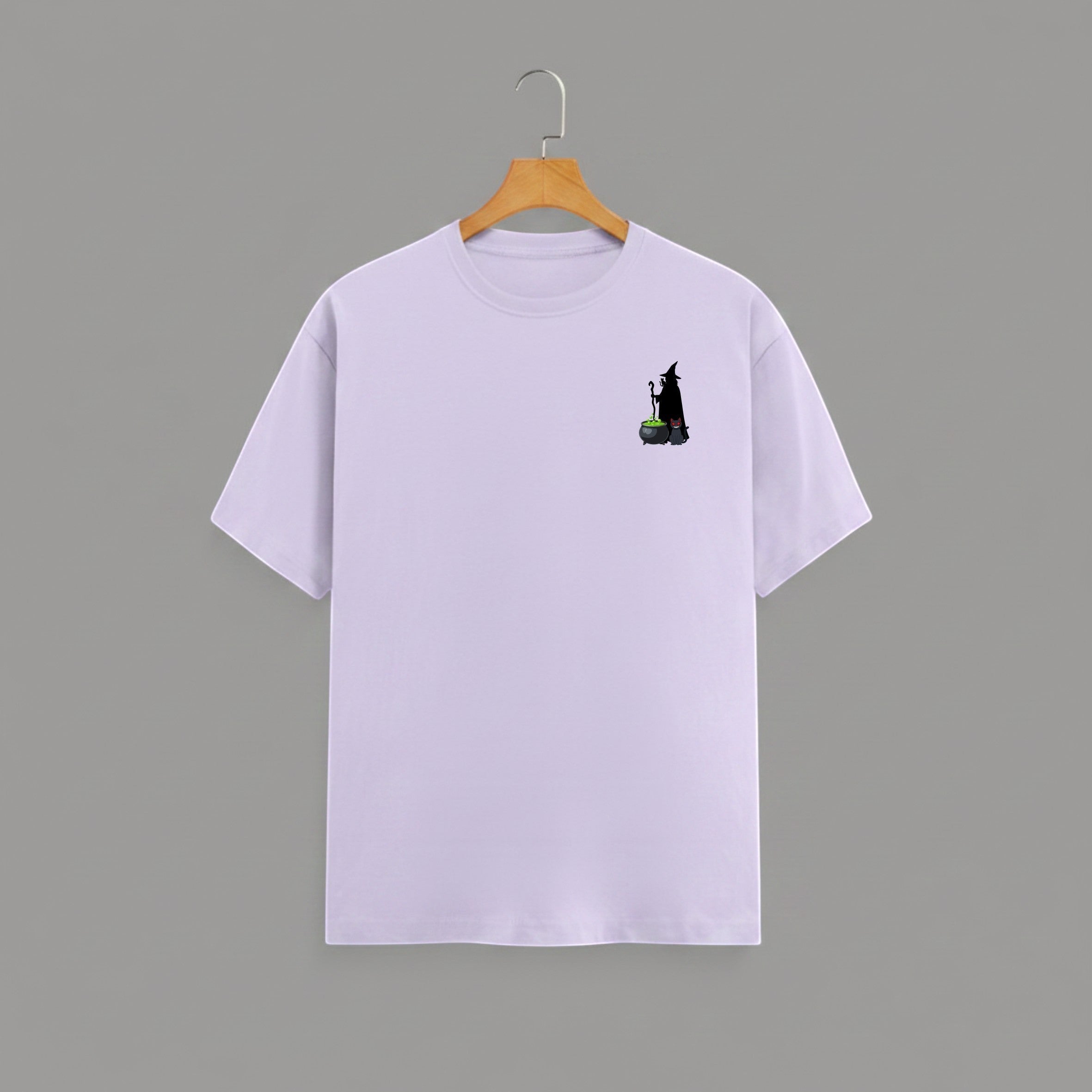 Witch Cauldron graphic t-shirt on LAVENDER unisex 100% cotton crew neck, subtle charming witch and cauldron graphic on chest, unique eye-catching magic detail, DTG print 300 DPI, 180 GSM breathable soft fabric